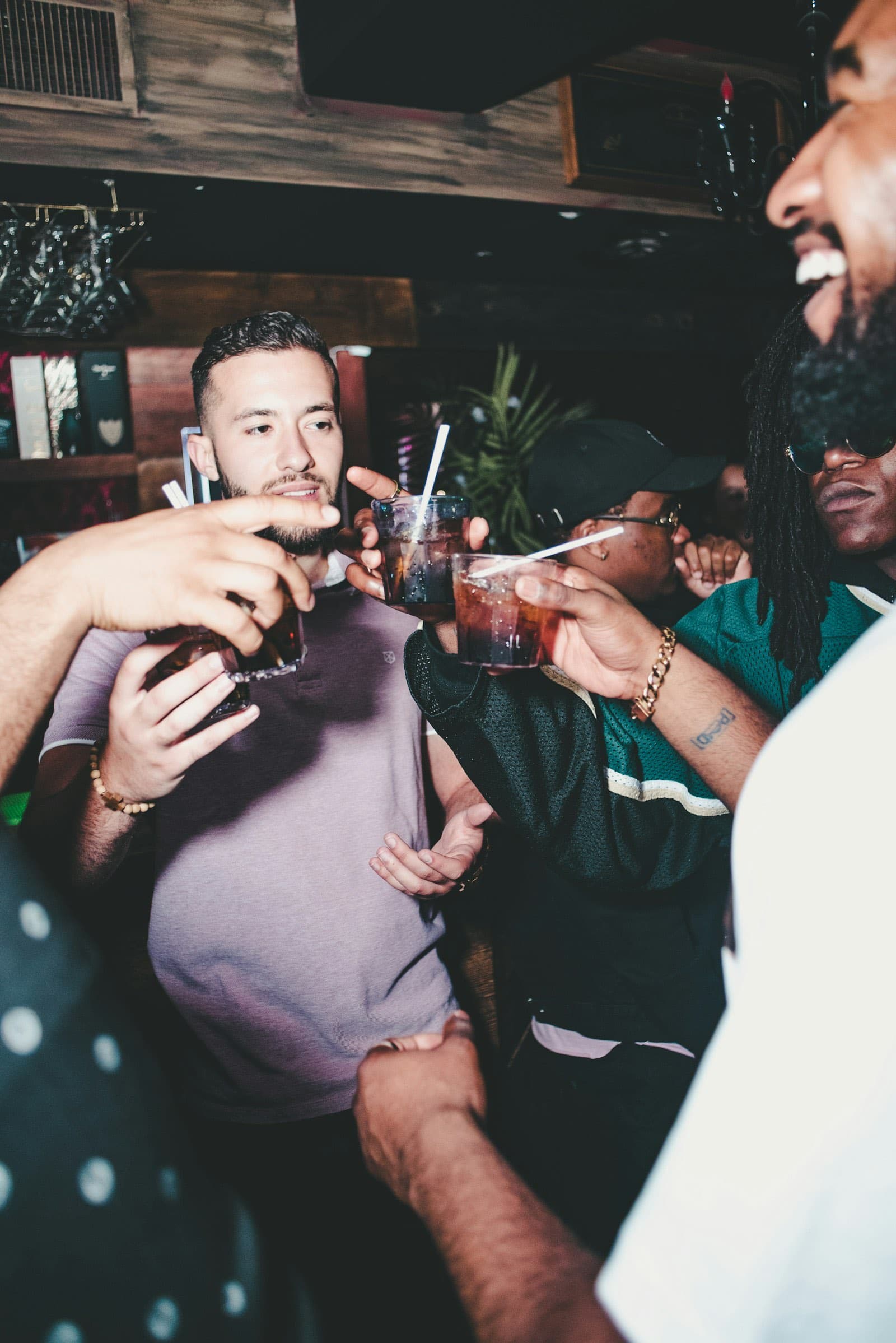 Friends toasting drinks at a bar